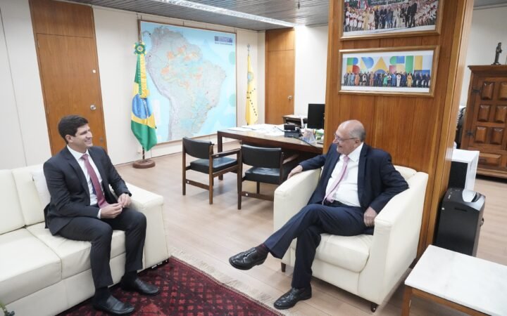 João Campos, então prefeito do Recife, e o vice-presidente Geraldo Alckmin conversam sentados em sala do ministério em Brasília